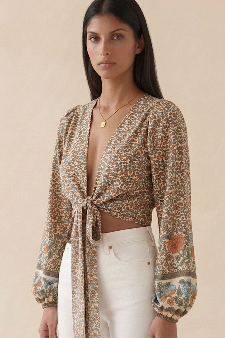 Woman wearing a floral blouse with a beige background